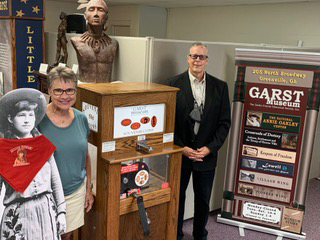 Photo of the Penny Pincher machine with museum staff