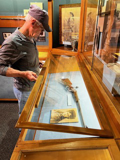 Photo of a man opening a display case